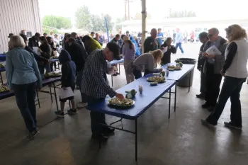 Attendees tasting cherimoya fruit.