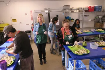 Volunteers prep fruit.