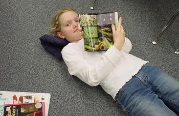 As a third grader, Jill Oberski is stretched out on the floor reading her 