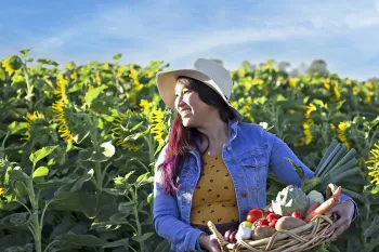 Woman carrying a basket of fruits and vegetables