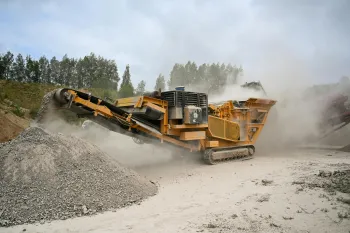 Rock crusher creating rock dust as gravel falls into a growing mound