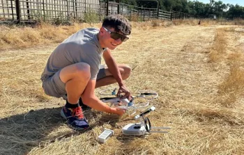 4-H youth getting their drone ready to take off