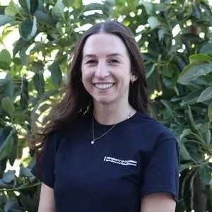 Portrait of person in front of green shrubery