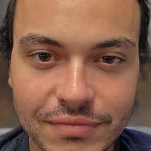 headshot of a man with black hair